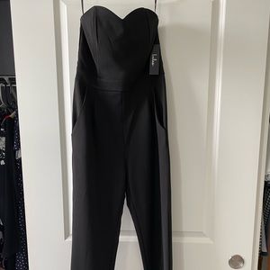Black, sleeveless jump suit - never been worn